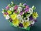 Close-up of a variety of bright flowers in a gift box on a dark green background. Gift for a wedding or birthday, Valentine`s Day