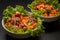 Close up. Vegan, vegetarian food. Greek salad with tofu and pine nuts. Black background