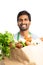 Close-up of vegetable bag held by grocery store employee