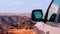 Close-up of a vehicle in the sand before a cliff.  Moon valley. Africa