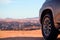 Close-up of a vehicle in the sand before a cliff.  Moon valley. Africa