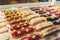 Close up of vendor's hands taking out cake from showcase in bakery.