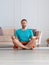 Close-up vertical photo of a middle-aged man meditating in home interior.