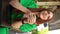 Close-up vertical portrait of happy dreaming young woman enjoying cup of coffee sitting at table in outdoor cafe terrace