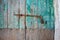 Close-up of very old grungy wooden weathered doors with door handle