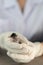 Close up of veterinarians hands in surgical gloves holding small bird, after attacked and injured by a cat