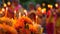 Close-up of vibrant orange flowers and candles at a Buddhist event. Blurred background with monks in ceremonial robes