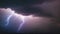 A close-up video capturing the awe-inspiring sight of a large cloud illuminated by a powerful lightning bolt, lightning in the