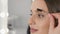 A close-up video that demonstrates the use of eyebrow gel to create the perfect fixation and shape. Beautician in the