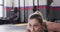 Close up video of determined caucasian woman doing push ups working out at a gym