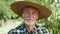 Close up video portrait of farmer in a straw hat.