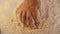 Close up video shot of hands of senior bakery chef applying flour on dough