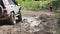 Close-up video of SUV wheel in the mud.