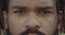 Close up view of african american guy with dreadlocks looking to camera. Headshot of serious young man face with