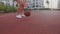 Close-up view of ambitious and focused basketball or streetball female player. She owns, controls the ball. Warm up