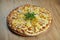 Close up view on Appetizing Hawaiian pizza with melted cheese, chicken and pineapple on wooden background Italian cuisine