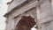 Close-up view of the Arch of Titus in Rome, Italy. Camera moving up.