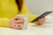 Close-up view of the arms of the caucasian woman holding an electronic book and a cup woth coffee. Concept of the education, exam