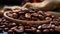 Close-up view of aromatic roasted coffee beans in a dark bowl, juxtaposed against a textured burlap fabric with a blurred colorful