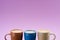 close up view of arranged colorful cups of coffee