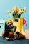 close up view of arranged rubber boots with flowers, flowerpots, gardening tools and birdhouse on wooden tabletop