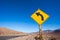 Close-up view of arrow yellow road sign in desert