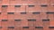 Close up view on Asphalt Roofing Red Shingles Background. Roof Bitumen Shingles - Roofing Construction, Roofing Repair. Red