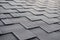 Close up view on Asphalt Roofing Shingles Background. Roof Shingles - Roofing. Shingles roof damage covered with frost.