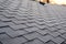 Close up view on Asphalt Roofing Shingles Background. Roof Shingles - Roofing. Shingles roof damage covered with frost.