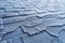 Close up view on Asphalt Roofing Shingles roof damage covered with frost.
