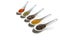 Close-up view of assorted aromatic seasonings in ceramic spoons