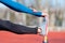 Close up view, athlete stretching on a running track.