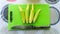 Close up view of baby corn on a green knife cutting board on a table at the kitchen