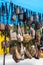 Close-up view of background of numerous black and brown leather bags hanging in rows