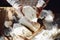 Close up view of baker kneading dough. Homemade bread. Hands preparing bread dough on wooden table. Preparing traditional