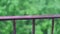 Close up view on balcony iron fence with raindrops during summer rain