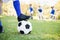 Close up view of balloon under football boots against children playing background