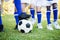 Close up view of balloon under football boots with children playing