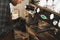 Close up view on barista hands and a cup pouring hot milk in it. Barista is preparing coffee in a coffee shop