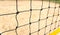 Close-up view of a beach volleyball net