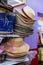 A close-up view of beautiful brown woven hats stacked on top of a retail shelf