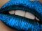 Close up view of beautiful woman lips with blue metallic lipstick