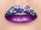 Close up view of beautiful woman lips with purple lipstick