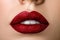 Close up view of beautiful woman lips with red matt lipstick