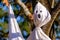 Close-up view of bed sheet ghost hanging in tree