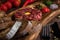 Close-up view on Beef Tartar with a raw egg yolk, capers, rye bread and chilis on a wooden board with spoon and fork. Shot made