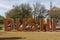 Close up view of big orange letters of word DUSHI. Willemstad. Curacao.