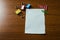 Close up view blank stationary paper set three colored clips and binders lying wooden table. Necessary accessories