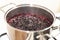 Close-up view of boiling blueberries. Cooking blueberry jam.