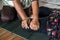 Close-up view of both hands of an elderly Thai female masseuse squeezing and bending the legs